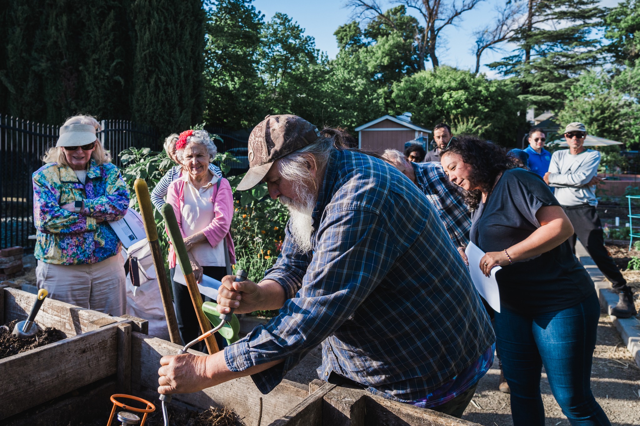 Master Gardener, Bill Maynard, demonstrates how to use compost crank during a composting workshop at Brooks Truitt Garden in Sacramento, Calif. on April 24, 2024. The workshop provided information on how backyard composting works, what materials should and should not compost, getting the right balance of food, air and moisture, maintaining compost pile, and home gardening tips.